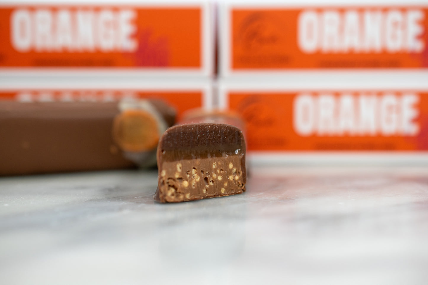 Handmade Irish orange chocolate bar sliced to show its caramel and crisp centre, a luxury gift idea for him.