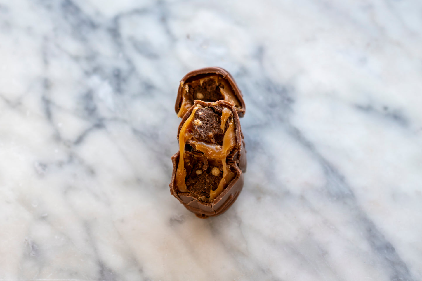Handmade Irish Surprise Bar broken to show stretchy caramel centre, luxury wedding favours and party gifts.