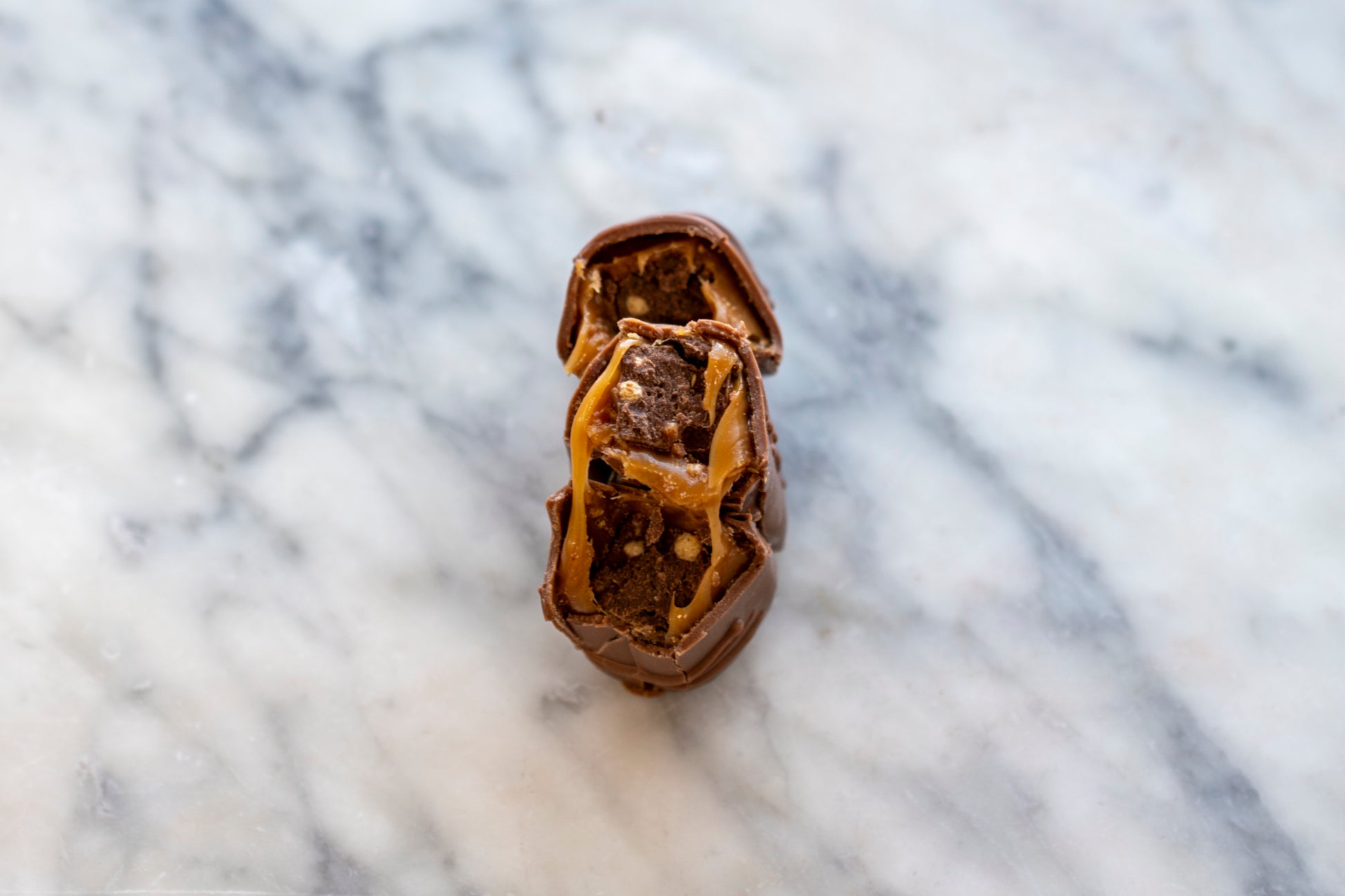 Handmade Irish Surprise Bar broken to show stretchy caramel centre, luxury wedding favours and party gifts.